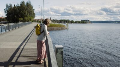 Woman on bridge looking at the water